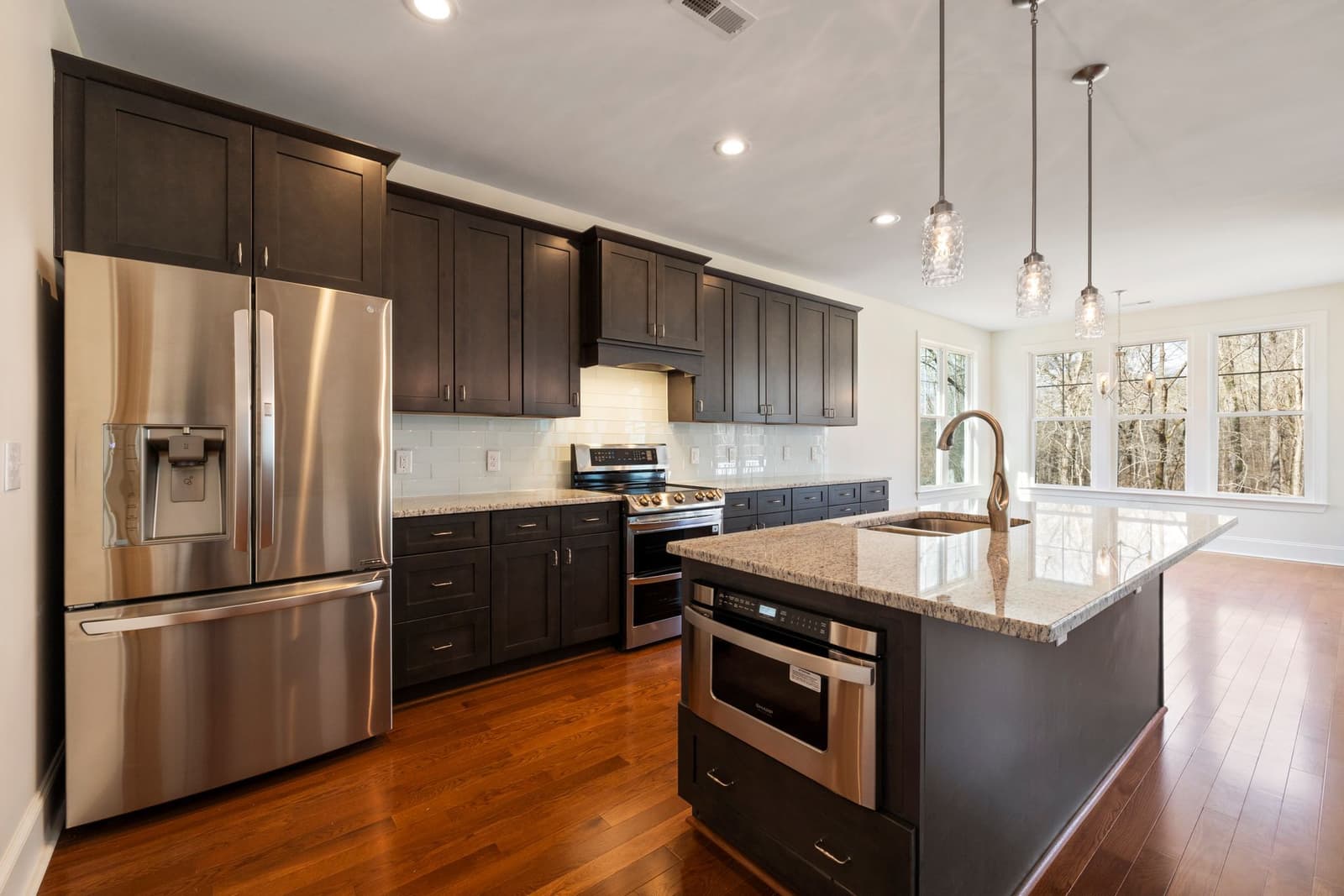 Finished kitchen remodel with custom cabinetry and granite island in Orlando, Florida